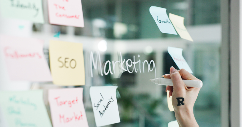 sticky notes on glass with various marketing aspects written on them