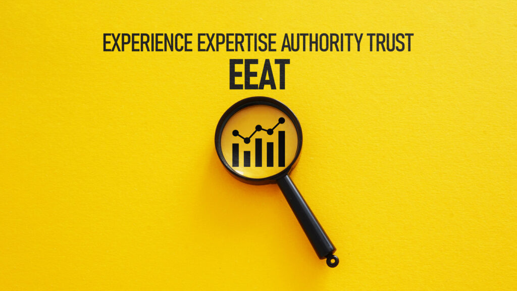 e-e-a-t - experience-expertise-authority-trust - with a magnifying glass showing a graph chart