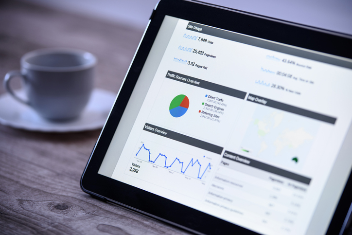 laptop screen showing a page with google analytics metrics and charts